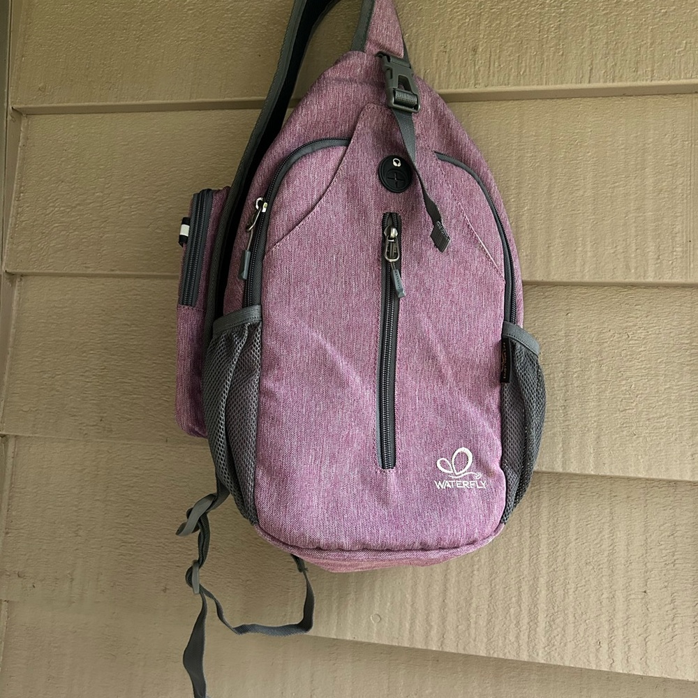 Watery daypack lavender sling bag hiking or traveling. Light purple